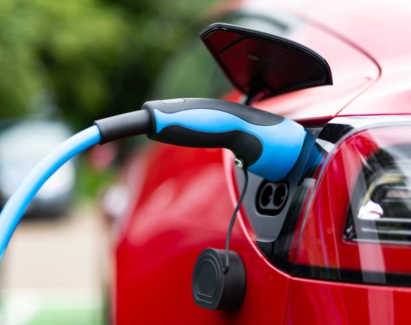 Electric car charging at plug in charge station in a public car park in Suffolk, UK